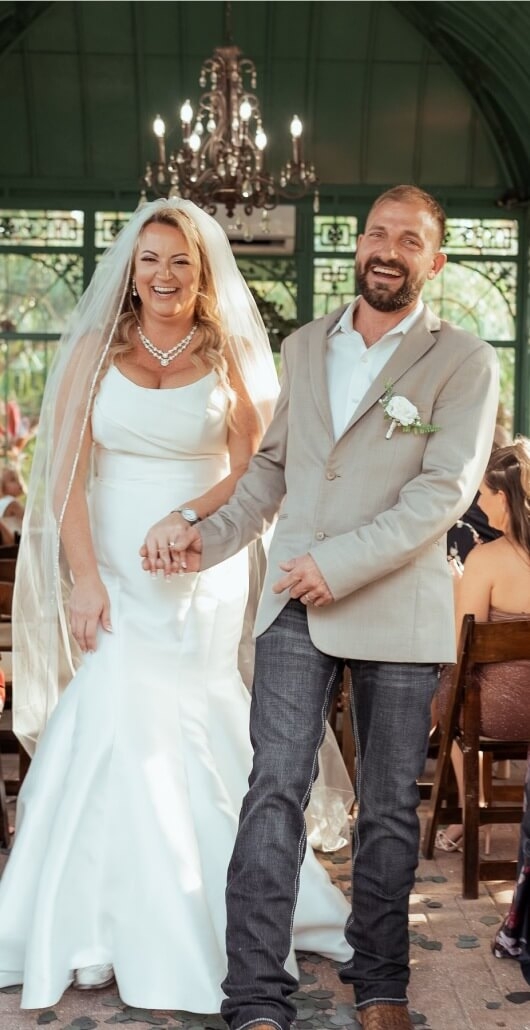 Couple wearing a white gown and a gray suit