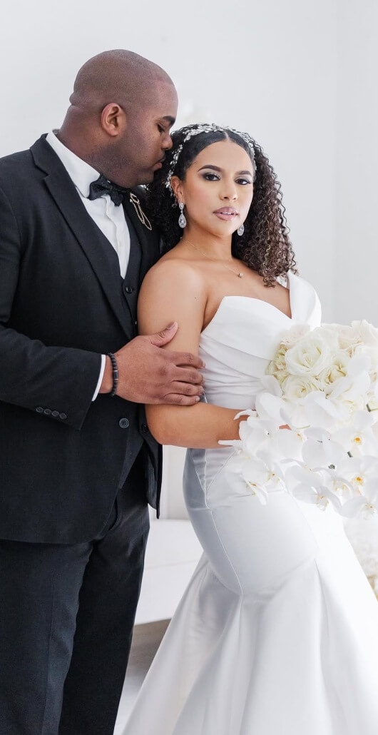 Couple wearing a white bridal dress and a black suit